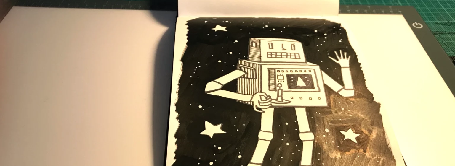 Skizzenbuch mit der ersten Zeichnung der Weihnachtskarte 2025, offen auf einem Zeichentisch liegend, daneben ein Acryl-Stift und weiteres Zeichenzubehör.